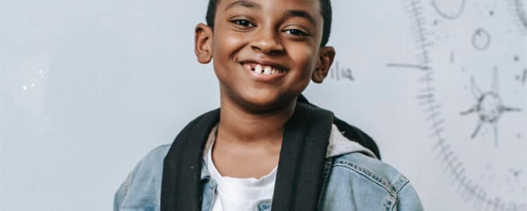 young boy smiling, possible gum disease